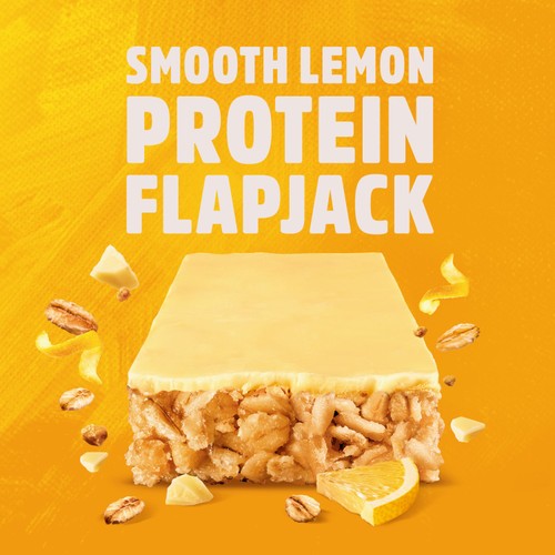 Smooth lemon protein flapjack with lemon slices and nuts on a yellow background
